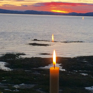 Took this picture of the sunset through a restaurant window. The candle was a lovely bonus!