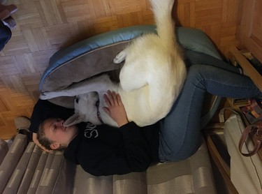 This is our daughter Alexandra, snuggling with our 7-month-old puppy; Tessa.  She is a rescue Husky mix from Animatch.  She came from Northern Quebec by plane with her siblings at 2 months old.  We adopted her 1 week after her arrival.  We think we might need a bigger bed....