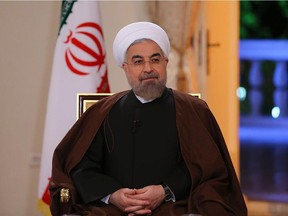 A handout picture released by the official website of the Iranian President Hassan Rouhani shows him during an interview broadcast live on state television on October 13, 2014 in Tehran.