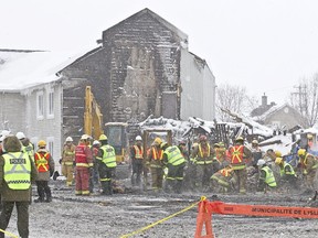 Police, firefighters and other investigators comb through the rubble of the Résidence du Havre seniors' home in L'isle-Verte, Jan. 28, 2014, looking for human remains and other clues.