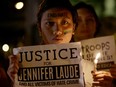 Protesters hold lighted candles and display messages on Oct. 14 in Manila to demand justice in the killing of Filipino transgender woman Jennifer Laude.
