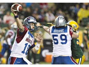 Montreal Alouettes quarterback Jonathan Crompton (18) makes the pass as Josh Bourke (59) defends against the Edmonton Eskimos during first half action in Edmonton, Alta., on Friday September 12, 2014.