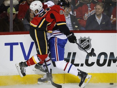 Canadiens' Jarred Tinordi slams into the Flames' Josh Jooris during first- period action in Calgary, Tuesday, Oct. 28, 2014.
