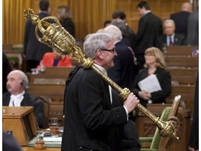 Sergeant-at-Arms Kevin Vickers carries the mace from the House of Commons at the conclusion of the session after the government was defeated on a vote of contempt of Parliament motion in Ottawa in 2011. Vickers, the man who is reported to have shot an assailant on Parliament Hill, is a former police officer with a background in providing security services for dignitaries, including members of the Royal Family.