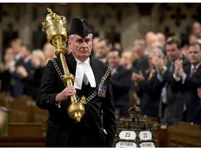 The Sergeant-at-Arms Kevin Vickers receives a standing ovation as he enters the House of Commons Thursday October 23, 2014 in Ottawa.