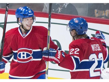 Montreal Canadiens' Lars Eller, left, celebrates with teammate Dale Weise after scoring against the New York Rangers during second period NHL hockey action in Montreal, Saturday, October 25, 2014.