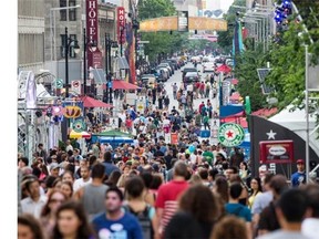 Crowds walk on Ste. Catherine St. in Place des Festivals during the Montreal International Jazz Festival in Montreal on Friday, July 5, 2013.