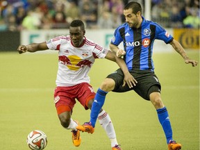 New York Red Bulls' Lloyd Sam, left, struggles for possession of the ball with the Impact's Andres Romero during MLS action in Montreal on April 5, 2014.