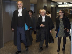Crown prosecutor Louis Bouthillier, left, and defence lawyer Luc Leclair, centre, arrive for the afternoon session at the murder trial for Luka Rocco Magnotta, Tuesday, Oct. 7, 2014 in Montreal.
