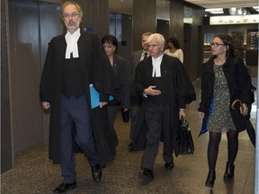 Crown prosecutor Louis Bouthillier, left, and defence lawyer Luc Leclair, centre, arrive for the afternoon session at the murder trial for Luka Rocco Magnotta, Tuesday, Oct. 7, 2014 in Montreal.