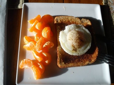 Poached egg on grain bread toast with clementines...starting the day off right while reading the Gazette.
