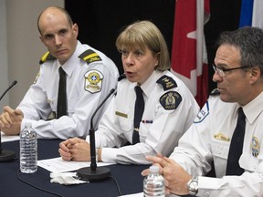RCMP inspector Martine Fontaine, flanked by Sylvain Guertin, left, of the Surete du Quebec and Bernard Lamothe of the Montreal police, responds to question during a news conference after a man drove a vehicle into two soldiers Monday