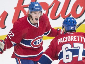 Max Pacioretty celebrates with teammate Dale Weise after scoring against the New York Rangers during the third period at the Bell Centre on Oct. 25, 2014. The Canadiens won the game 3-1.