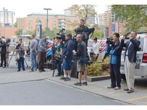 Members of the media wait outside the Montreal courthouse, Monday, September 29, 2014, for Luka Magnotta, who was to arrive for the start of his first degree murder trial.  The trial is expected to last about two months.
