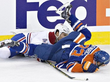 Montreal Canadiens' Mike Weaver and Edmonton Oilers' Matt Hendricks collide during second-period action in Edmonton on Monday, Oct. 27, 2014.