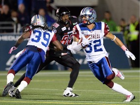 Montreal Alouettes' Mitchell White runs the ball after making an interception against the Ottawa Redblacks during CFL action in Ottawa on Oct 24, 2014.