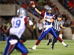 Quarterback Jonathan Crompton of the Montreal Alouettes throws a pass to teammate S.J. Green  in a game against the Ottawa Redblacks at TD Place Stadium in Ottawa on Sep. 26, 2014.