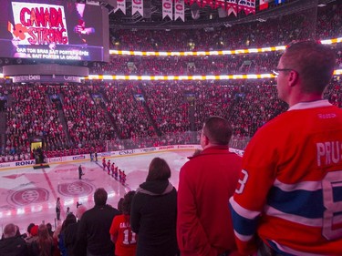 Montreal Canadiens' fans listen to 'O Canada' being broadcast on the big screen from Ottawa prior to an NHL hockey game between the New York Rangers and the Canadiens in Montreal, Saturday, October 25, 2014. A ceremony co-ordinated between Canadian Tire Centre in Ottawa, Bell Centre in Montreal and Air Canada Centre in Toronto, fans in all three arenas observed a lengthy moment of silence to honour slain soldiers Cpl. Nathan Cirillo and Warrant Officer Patrice Vincent.