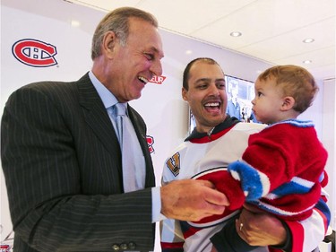 Montreal Canadiens legend Guy Lafleur greets Habs fans Michael Palmer and his son Logan at tailgate outside the Bell Centre prior to the Habs home opener in Montreal Thurssday October 16, 2014.  The Palmers are from Toronto.