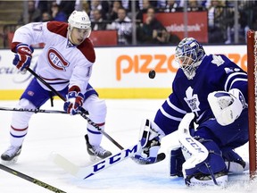 Montreal Canadiens' Rene Bourque looks on as Toronto Maple Leafs goalie Jonathan Bernier makes a save during first period NHL action in Toronto on Wednesday, October 8, 2014.