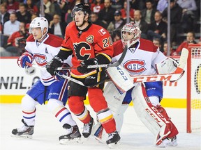 Curtis Glencross (#20) of the Calgary Flames looks for an opportunity in front of the net as Andrei Markov (#79) (L) and Carey Price (#31) (R) of the Montreal Canadiens defend during an NHL game at Scotiabank Saddledome on October 9, 2013 in Calgary.