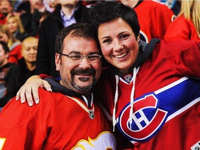 A Flames fan poses with a fan of the Canadiens during an NHL game at Calgary's Scotiabank Saddledome on Oct. 28, 2014. The Canadiens beat the Flames 2-1 in a shootout.