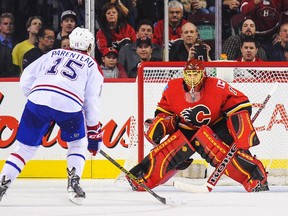 The Canadiens' P.A. Parenteau scores game-winning shootout goal against Flames goalie Jonas Hiller during game at Calgary's Scotiabank Saddledome on Oct. 28, 2014.