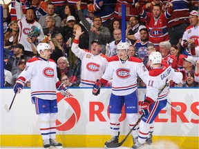 The Canadiens' Alex Galchenyuk (centre) celebrates with teammates Tomas Plekanec (left) and Brendan Gallagher after scoring goal against the Oilers during game in Edmonton on Oct. 10, 2013. The Montreal Canadiens won the game 4-1.