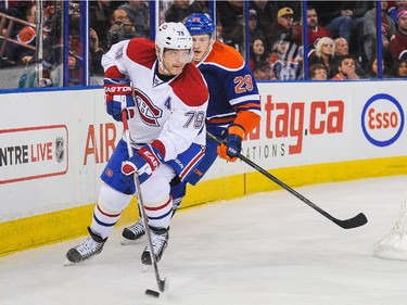 Andrei Markov of the Montreal Canadiens skates the puck ahead of Leon Draisaitl of the Edmonton Oilers during action on Monday, Oct. 27, 2014. in Edmonton.