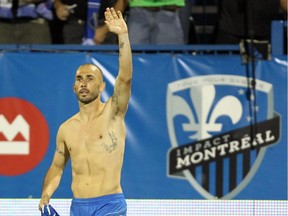 Impact forward Marco Di Vaio waves to fans as he celebrates his second goal of the game against D.C. United by taking off his jersey during an MLS match at Saputo Stadium on Aug. 17, 2013.