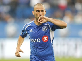 The Impact's Marco Di Vaio kisses his hand while celebrating after scoring a goal against D.C. United during an MLS game at Saputo Stadium on Aug. 17, 2013.