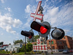 A rail crossing sign flashes.