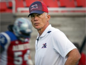 I don't play with numbers and don't want to play with numbers," Montreal Alouettes head coach Tom Higgins says. He's seen here watching his team warm up prior to a game against the Ottawa Red Blacks in Montreal Friday, Aug, 29, 2014.