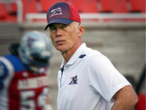 Montreal Alouettes head coach Tom Higgins watches his team warm up prior to Canadian Football League game against the Ottawa Red Blacks in Montreal Friday August 29, 2014.