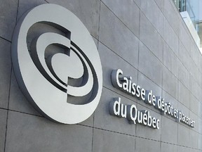 A woman walks by the main logo of the Caisse de dépôt et placement du Québec on February 25, 2009.