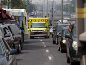 An Urgences-Santé ambulance tries to get through heavy traffic on Decarie Blvd. near Queen Mary Road in Montreal on Wednesday July 3, 2013.