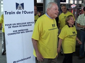 A delegation of about 15 people, including Train de l’Ouest spokesman Clifford Lincoln and Baie-d'Urfé Mayor Maria Tutino wear bright yellow T-shirts as they head to meet the Transport minister. (Gazette file photo)