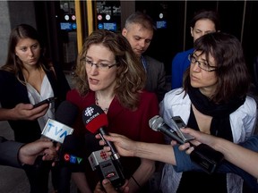 Heidi Rathjen, in red dress, and Nathalie Provost, black scarf, talk to reporters following the ruling by the Quebec Court of Appeal on the federal long-gun registry on Thursday, June 27, 2013. The court overturned a ruling that would have allowed the province to keep its federal long-gun registry records.