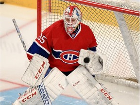 Canadiens goalie Dustin Tokarski stops puck during warmup before Game 2 of Eastern Conference final playoff series against the New York Rangers in Montreal  on May 19, 2014.