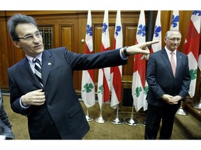 In this file picture from 2009, then Projet Montreal leader and new member of Montreal's executive committee Richard Bergeron (L), spoke to journalists as then mayor Gérald Tremblay looked on after the city's new committee was introduced. Now, five years and one day later, Bergeron has been named to the executive committee by Mayor Denis Coderre.