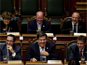Nov. 18, 2013: Montreal Mayor Denis Coderre and fellow councillors laugh during the opening moments of the first city council meeting under newly elected mayor.