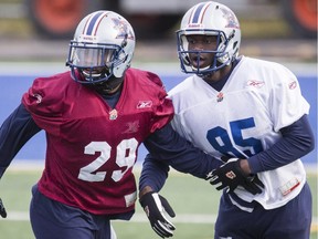 Montreal Alouettes players Ed Gainey, left, and Ismael Bamba, right, take part in a team practice in Montreal on Thursday, November 7, 2013. The Alouettes will face the Hamilton Tiger-Cats in their CFL eastern division semifinal on Sunday.