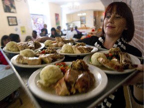 Caseworkers Allison Lemieux serves Thanksgiving lunch to clients at the Chez Doris women's shelter in Montreal, Friday, October 10, 2014 at 12:12 PM. Since last spring the centre has had to cut back on weekend hours due to funding problems.