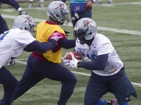 Montreal Alouettes S.J. Green, right, makes his way past teammates, during Alouettes practice on Friday October 10, 2014.