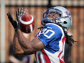 Alouettes kick-returner James Rodgers makes an over-the-shoulder catch of a punt from Saskatchewan Roughriders kicker Josh Bartel during Canadian Football League game in Montreal on Oct. 13, 2014.