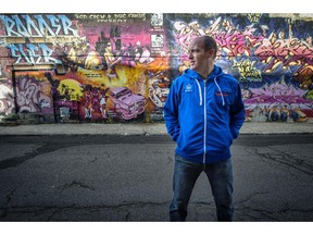 MONTREAL, QUE.: OCTOBER 14, 2014 --  Graphic artist Mike Vallee poses in front of a graffiti wall near his business on Notre-Dame St. in Lachine. Tuesday, October 14, 2014. (Peter McCabe / THE GAZETTE)