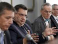 In this file picture from Oct. 14, Mayor Denis Coderre, middle, Pierre Desrochers, president of the city's executive committee , left and city manager Alain Marcoux attend a presentation on the city's three-year capital works program outlining major expenditures on infrastructure.