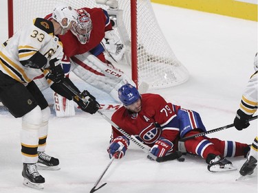 Montreal Canadiens Andrei Markov blocks a shot in front of goalie Carey Price as Boston Bruins Zdeno Chara, 33, and Torey Krug try to dig it out during National Hockey League game in Montreal Thursday October 16, 2014.