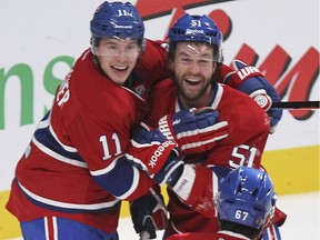 Montreal Canadiens Brendan Gallagher, left, David Desharnais and Max Pacioretty celebrate Pacioretty's first period goal against the Boston Bruins during National Hockey League game in Montreal Thursday October 16, 2014.