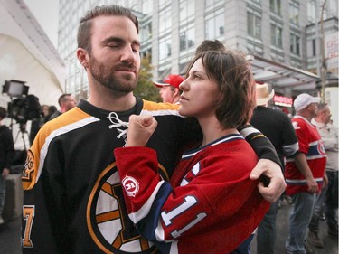 Montreal Canadiens fan Susie Sorrelle, from Montreal but currently living in Dallas gets in the face of Boston Bruins fan Phil Anderson at tailgate outside the Bell Centre prior to the Habs home opener in Montreal Thursday October 16, 2014.  The two had never met before.